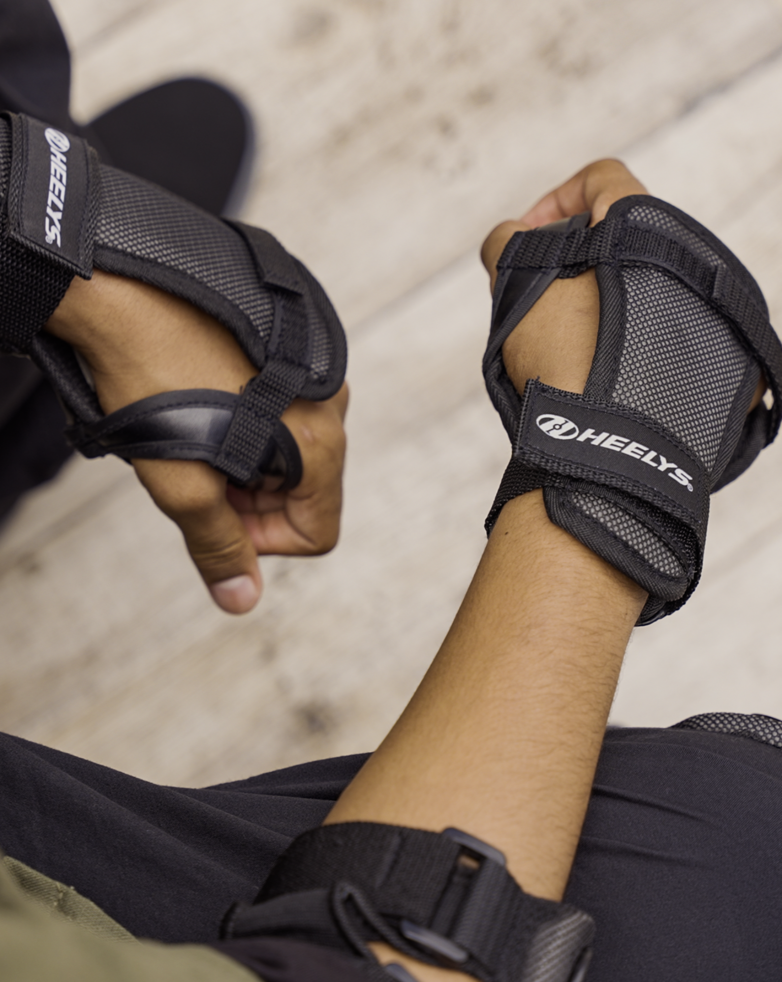 Person wearing Heelys protective wrist pads.
